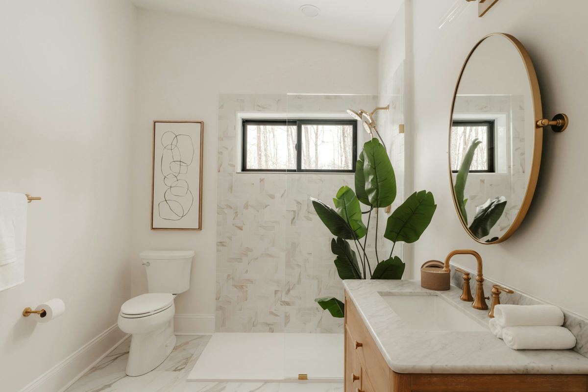 Modern bathroom with timber vanity, marble top and round mirror